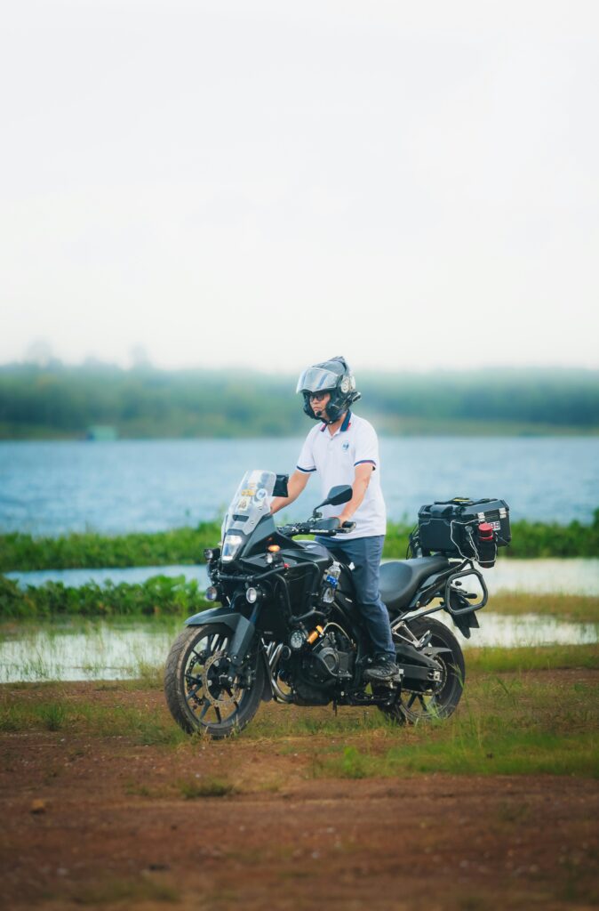 Happy man riding a motorcycle after successful application of Motorcycle Loans from Policemen's Federal Credit Union.